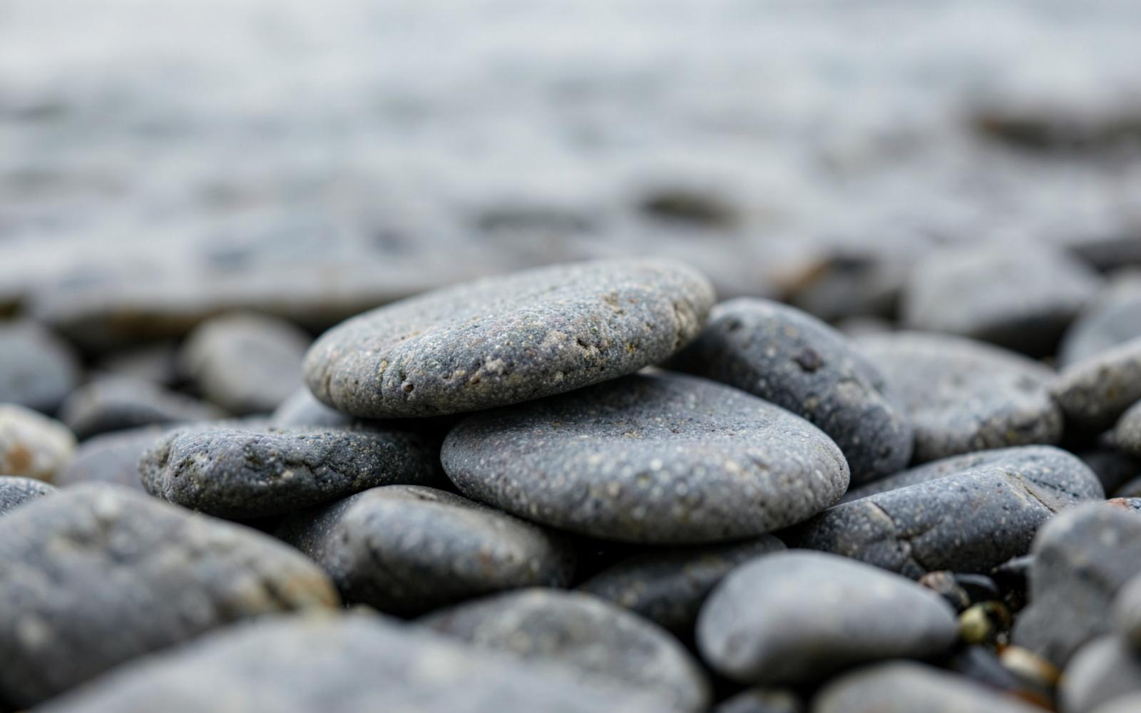 Smooth grey beach stones stacked on a Pacific Northwest shore